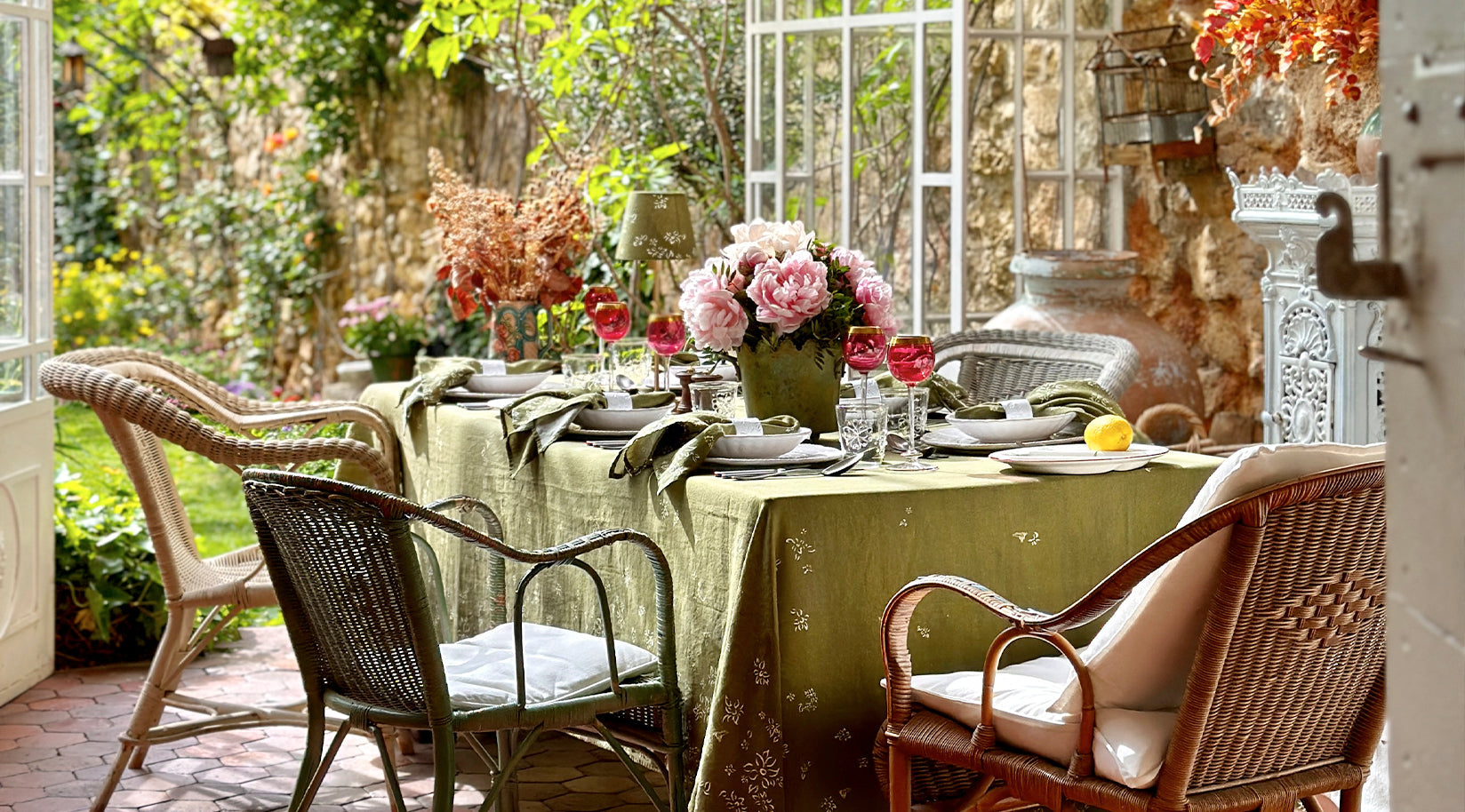 Cosy dining setup with a table, chairs, and floral arrangements in a |Garden Conservatory setting.