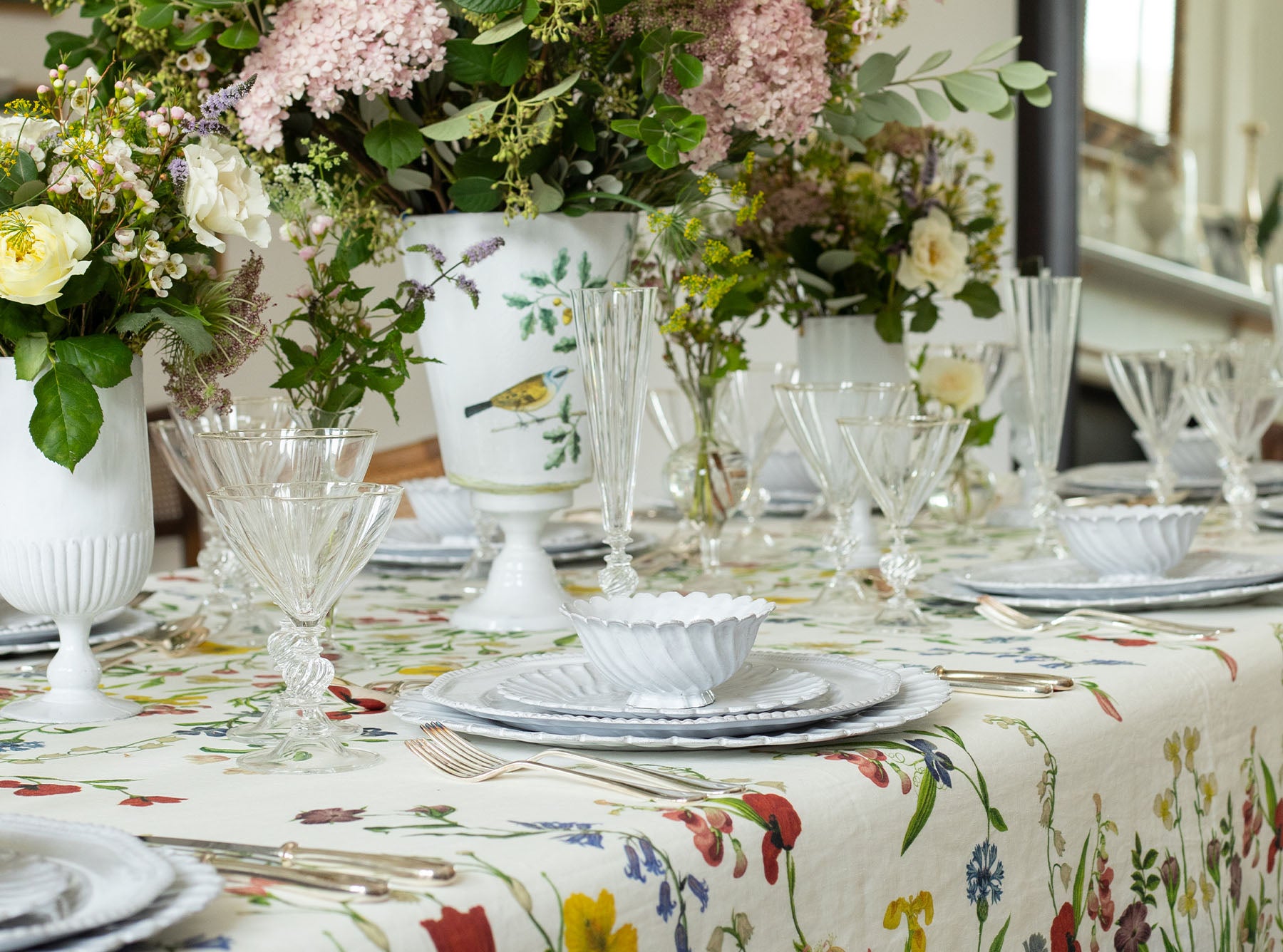 Elegant table setting with floral Botanical Wildflower tablecloth, glasses, and centerpieces.